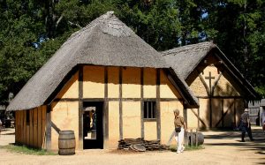 photo shows a thatched roof cottage similar to those of the first Jamestown settlement.